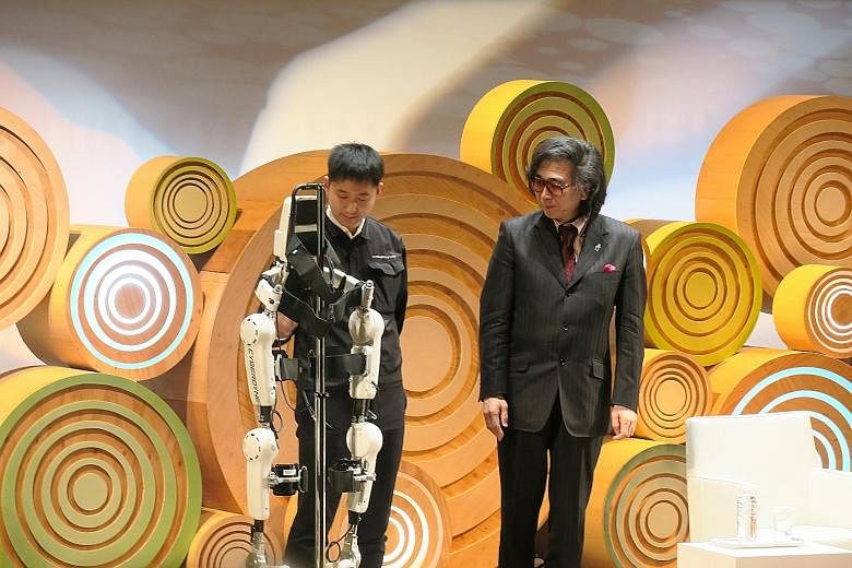 Dr Yoshiyuki Sankai (right), a pioneer in cybernics, at a demonstration of the Hybrid Assistive Limb, which has been billed as the world's first cyborg-type robot to assist and enhance human motion.
