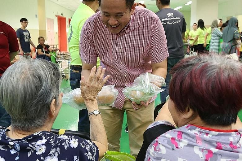 Senior Parliamentary Secretary for Health Amrin Amin speaking to attendees at a supermarket event held in Viva Business Park in Chai Chee yesterday. The pilot programme gives residents a chance to try out healthier ingredients and to show them the fo