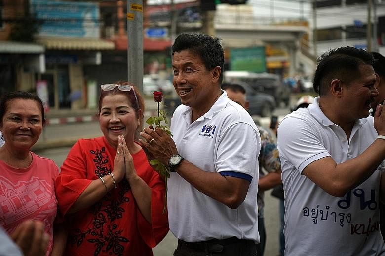 Dr Chadchart Sittipunt (centre), one of three Pheu Thai candidates for prime minister, campaigning last Saturday with fellow party member Wan Yubamrung, who is contesting in the Bang Bon district of Bangkok.