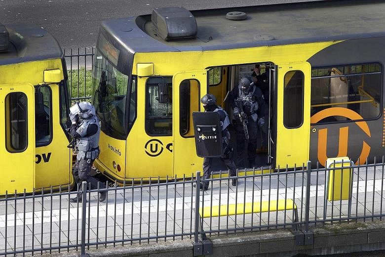 Dutch Special Police Forces inspecting the tram (top) yesterday after the attack, which the police believe was committed by a Turkish man named Gokmen Tanis (above).