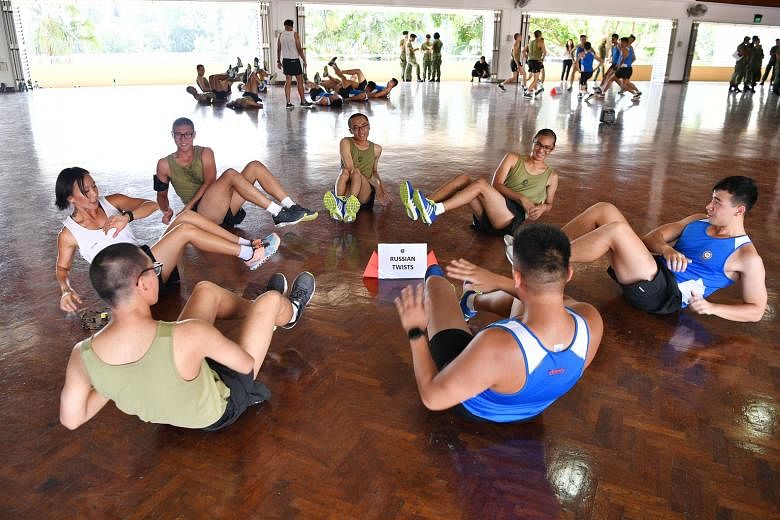 Recruits exercising at School Five of the Basic Military Training Centre yesterday. "The mission and purpose of School Five is to transform recruits into confident, competent and committed soldiers," said its commanding officer, LTC Sim Kian Hwa.