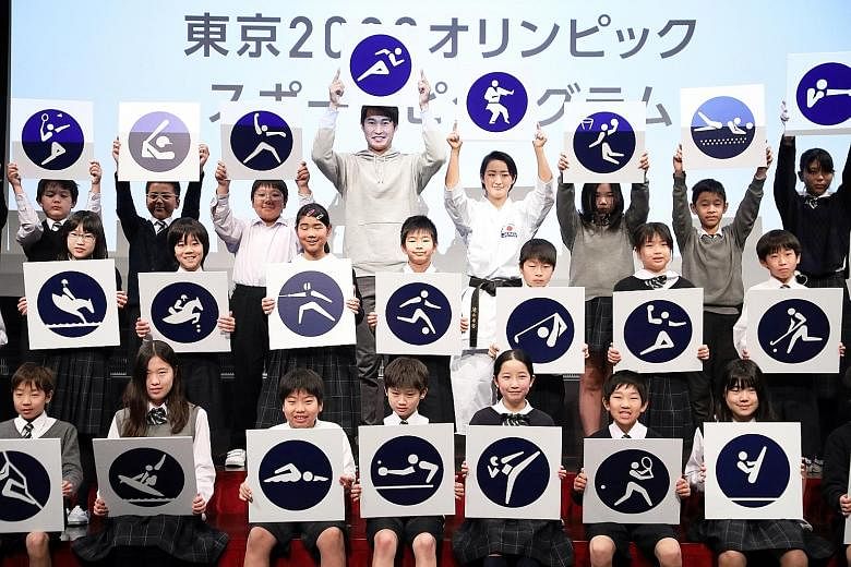 Japanese athletes and school children coming together to display the Tokyo 2020 sports pictograms during an event in Tokyo last week. Japan is an hour ahead of Singapore, which means that the 2020 Olympic Games will be held at optimal timing for view