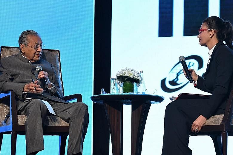 Malaysian Prime Minister Mahathir Mohamad with Bursa Malaysia chairman Shireen Ann Zaharah Muhiudeen at Invest Malaysia 2019 yesterday. He said Malaysia remains committed to trade with all key partners, particularly nations with "close and strongest 
