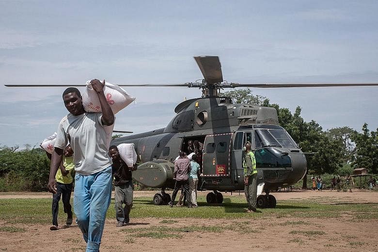 Relief supplies being delivered to parts of southern Malawi last Friday. Cyclone Idai has killed at least 56 people in the country. People inspecting the damage after Cyclone Idai made landfall in central Mozambique last Saturday. More than 1,000 peo