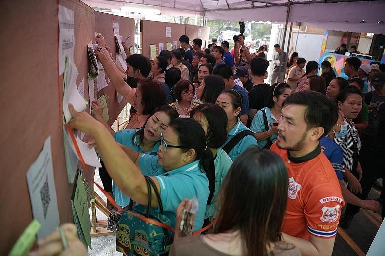 Thais looking for their names at a voting centre in the Bangkapi district of Bangkok during early voting on Sunday. There was an 86.98 per cent turnout among the 2.6 million early voters registered, Mr Ittiporn Boonpracong, chairman of the Election C