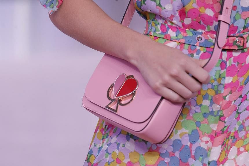 Nicola Glass' first collection for Kate Spade includes flowing satin pieces sporting puff sleeves and subtle ruffles, cropped knits and crossbody bags with spade-shaped twist locks.