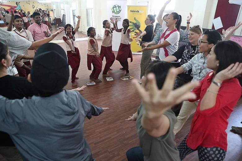 Singaporean dancer Muhammad Noramin (in black) taught the children Malay dance gestures, accompanied by music provided by Indian Carnatic vocalist Manjula Ponnapalli (far right).