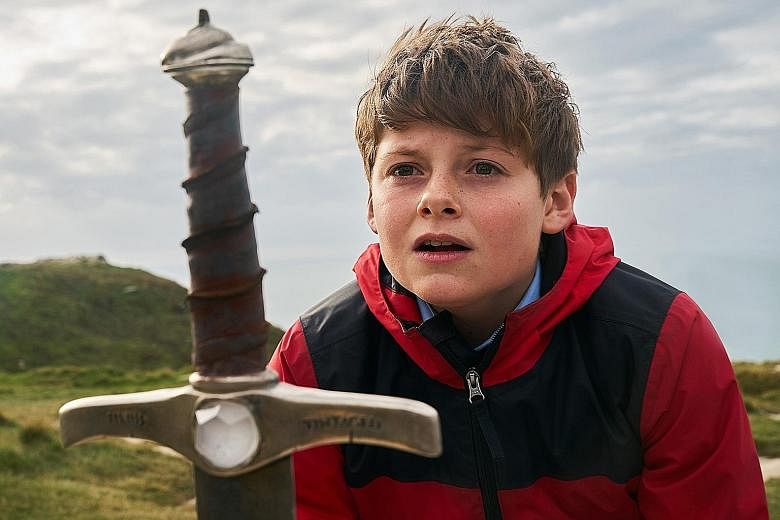The Kid Who Would Be King stars Louis Ashbourne Serkis (top) as Alex, whose life changes when he pulls out a sword from a stone and awakens an evil sorceress, played by Rebecca Ferguson (above).