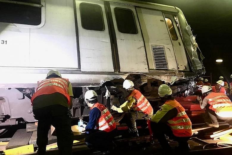 Engineers inspecting a damaged MTR train after it collided with another one during a test run inside a tunnel on Monday. The accident led to a two-day service disruption on the Tsuen Wan Line between Central and Admiralty stations.