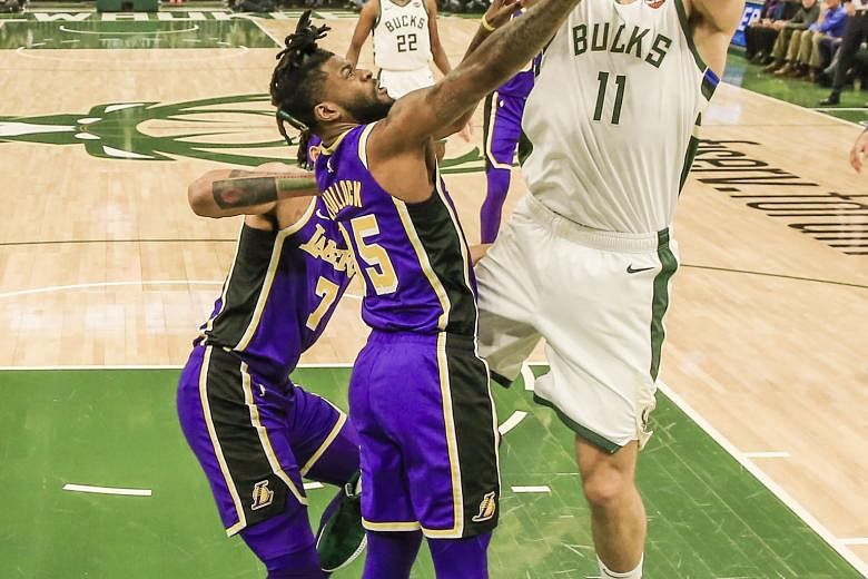 Milwaukee Bucks centre Brook Lopez shooting over Los Angeles Lakers guard Reggie Bullock during their 115-101 NBA win on Tuesday. The Bucks have already clinched a play-off spot while the Lakers are set to miss out.