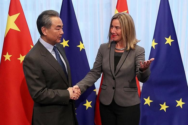 Chinese Foreign Minister Wang Yi being welcomed by Ms Federica Mogherini, the European Union's foreign policy chief, ahead of a meeting in Brussels on Monday. Mr Wang said earlier this month that relations between China and Europe were in good shape,