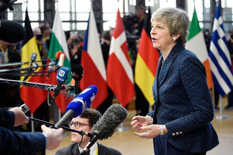 British Prime Minister Theresa May speaking to the press as she arrived yesterday in Brussels on the first day of an EU summit. Mrs May made a last-ditch plea to the bloc's 27 other leaders to hand her a Brexit delay until June 30, a request that she