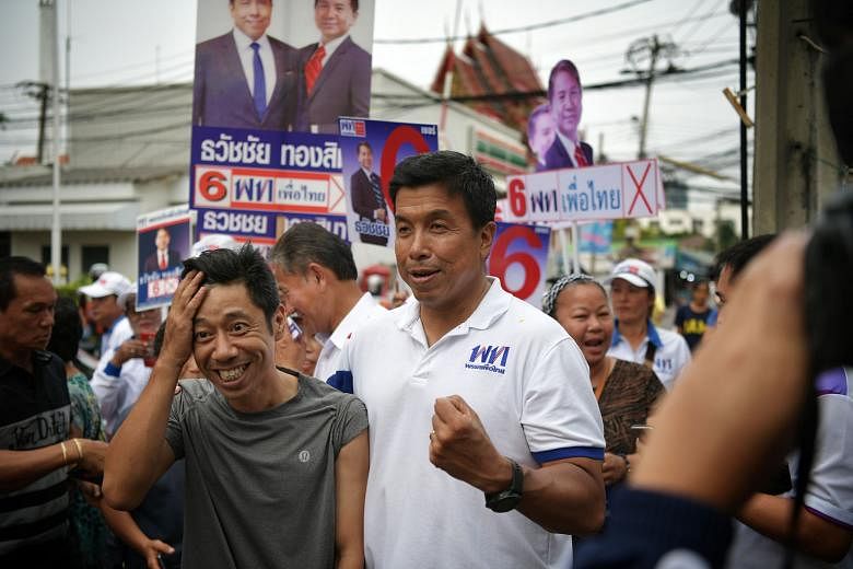 Mr Thanathorn Juangroong-ruangkit, leader of the Future Forward Party, with some students while campaigning at the King Mongkut's University of Technology Thonburi. Mr Chadchart Sittipunt, one of the Pheu Thai party's prime ministerial candidates, wi