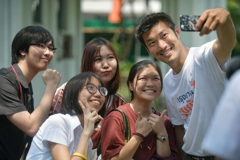 Mr Thanathorn Juangroong-ruangkit, leader of the Future Forward Party, with some students while campaigning at the King Mongkut's University of Technology Thonburi. Mr Chadchart Sittipunt, one of the Pheu Thai party's prime ministerial candidates, wi