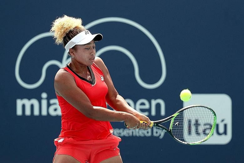 Mari Osaka returning a shot to fellow wild card Whitney Osuigwe during the Miami Open at Hard Rock Stadium on Thursday in Miami Gardens, Florida. Mari acquitted herself well despite a 6-2, 6-4 loss.