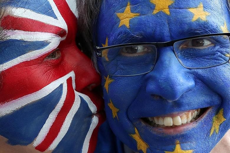 Protesters with European Union and British flags painted on their faces seen ahead of an EU summit in Brussels, Belgium, on Thursday.