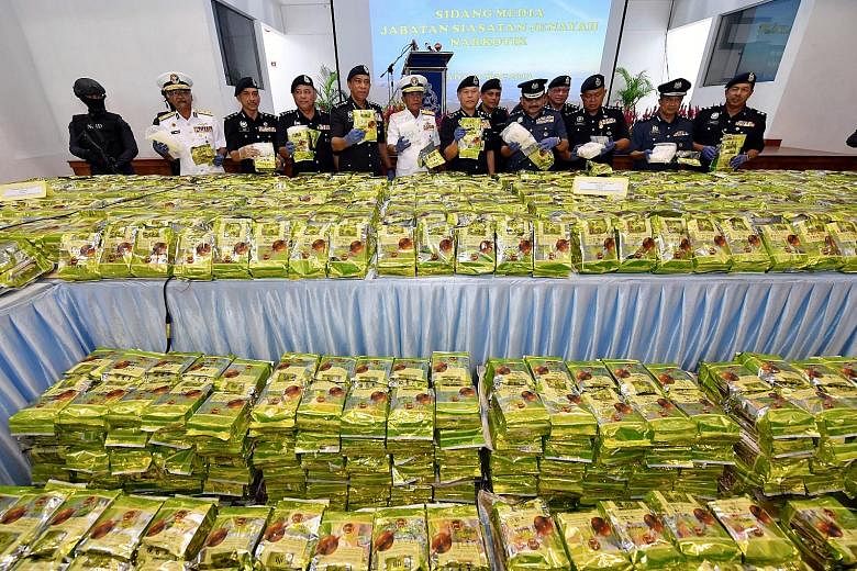 Malaysian drug busters with the seized 2,060kg of drugs believed to be syabu, or crystal methampheta-mine, disguised as Chinese tea.