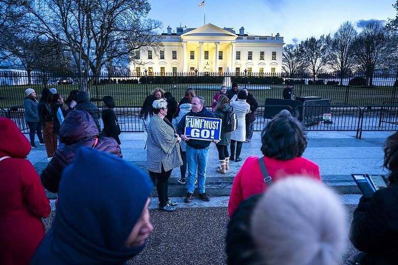 People gathering outside the White House at dusk after Special Counsel Robert Mueller delivered his report on Russia's interference in the 2016 US presidential election to the Department of Justice on Friday. A February poll by the Washington Post fo