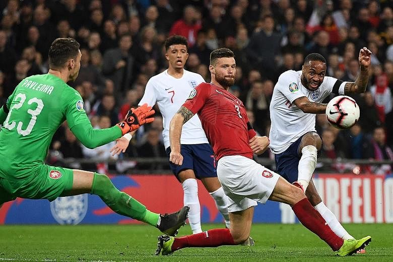 Raheem Sterling curling the ball around defender Ondrej Celustka and goalkeeper Jiri Pavlenka for his second goal to put England 3-0 up against the Czech Republic in their Euro qualifier at Wembley on Friday.