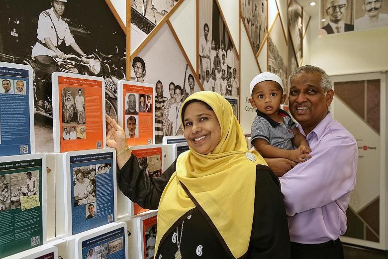 Madam Mumtaj Bivi, with her husband Naseer Ghani and their grandson Arfan Hassan Ghani Anwar, with old photos of her parents and ancestors from Tamil Nadu, India, at the Nagore Dargah Indian Muslim Heritage Centre in Telok Ayer. The free photo exhibi