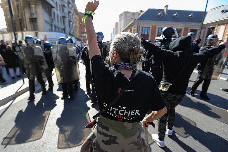 A demonstrator in Nice, France, gesturing at riot police officers during the 19th consecutive weekend of protests against President Emmanuel Macron's government yesterday.