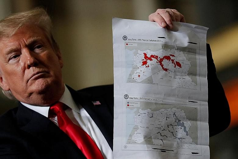 Fighters of the US-backed Syrian Democratic Forces celebrating on Saturday their victory over ISIS in the village of Baghuz in Syria, where the Islamist militants made their last stand. US President Donald Trump with maps of Syria and Iraq showing th