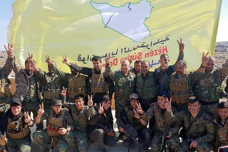 Fighters of the US-backed Syrian Democratic Forces celebrating on Saturday their victory over ISIS in the village of Baghuz in Syria, where the Islamist militants made their last stand. US President Donald Trump with maps of Syria and Iraq showing th