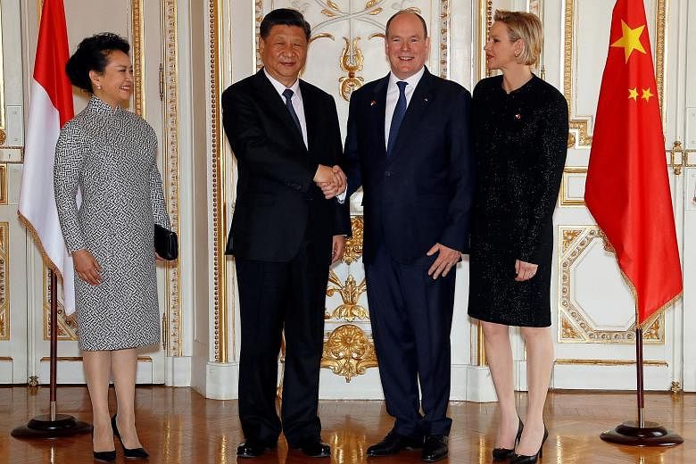 Prince Albert II of Monaco and his wife, Princess Charlene, welcoming Chinese President Xi Jinping and his wife, Ms Peng Liyuan, at the Monaco Palace yesterday. Mr Xi will meet French President Emmanuel Macron today.