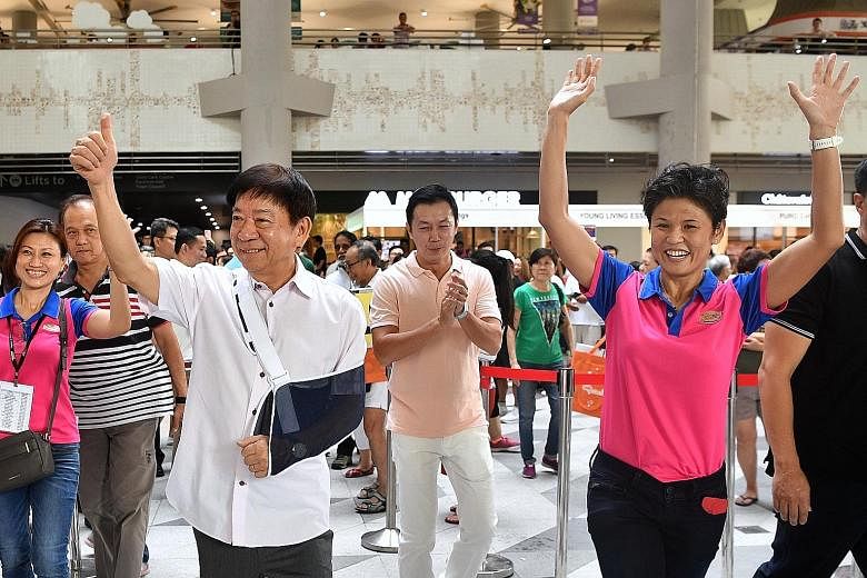 Transport Minister Khaw Boon Wan, Dr Lim Wee Kiak, a fellow MP for Sembawang GRC, and grassroots leader Poh Li San (right) arriving at the Women's Festival 2019 held at Kampung Admiralty yesterday. It was Mr Khaw's first appearance at a grassroots ev