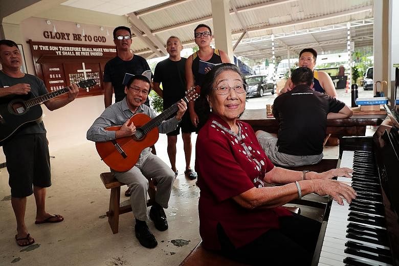 Madam Khaw Seow Wah playing worship songs with Pastor Simon Neo (seated with guitar) as well as residents and staff of Christian halfway house Breakthrough Missions. Madam Khaw, a long-time volunteer at the halfway house, has helped to reconcile more