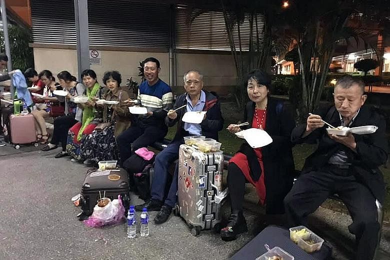 A posting on Facebook showing tourists eating packed food during a long wait to clear Customs at the Sultan Abu Bakar Complex in Johor.