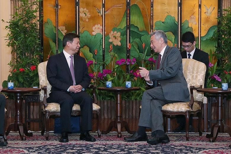 Chinese Communist Party's Minister of the International Department Song Tao with Prime Minister Lee Hsien Loong at the Istana yesterday. The two leaders discussed the deepening cooperation between China and Singapore in multifaceted areas, including 