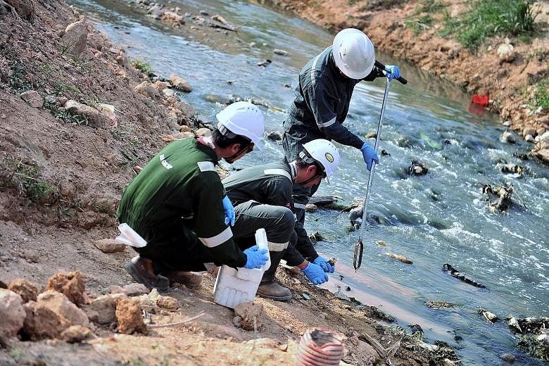 Samples being collected at Sungai Kim Kim on March 19 to check air, water and soil quality following the dumping of chemical waste in the area.