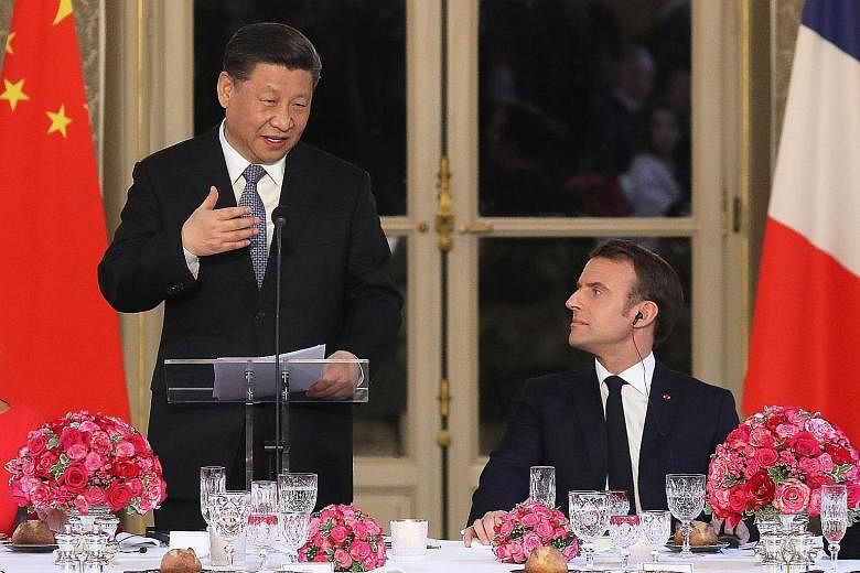 Chinese President Xi Jinping making a speech as French President Emmanuel Macron looks on during a state dinner at the Elysee Palace in Parison Monday. China has placed a $47 billion order with the European planemaker Airbus.