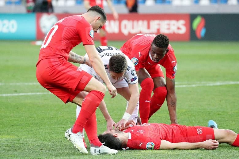 Switzerland's Fabian Schar unconscious after a clash of heads with Jemal Tabidze of Georgia in their Euro 2020 qualifier last Saturday.