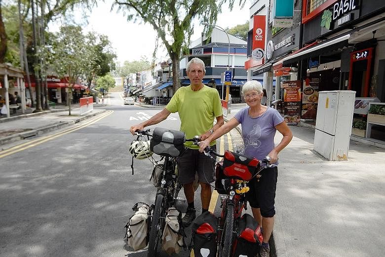 Mr Llyod cycling up a motorway in Athens, Greece. Some parts of the journey can be surreal for him, like cycling on long, empty roads in the Gobi Desert. Mr Paul Llyod and his wife Christine, with their trusty bikes that took them across continents: 