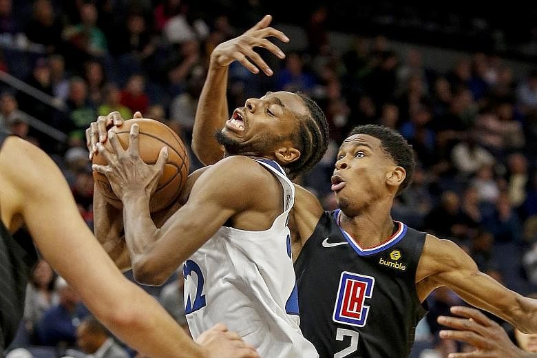 Minnesota Timberwolves forward Andrew Wiggins driving to the basket against the Los Angeles Clippers' Shai Gilgeous-Alexander during the Clippers' 122-111 win on Tuesday. The Clippers became the fifth team in the Western Conference to clinch a play-o