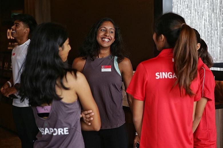 National sprinter Shanti Pereira, 22, chatting with teammates during the launch of the Singapore Open Track and Field Championships at the National Stadium's OCBC Lounge yesterday. She will be competing in the women's 200m and 4x100m mixed relay toda