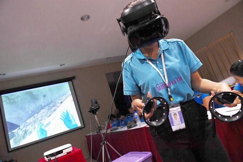 A Thai forensic police officer using a virtual reality headset to search for victims in a simulated city in ruins.