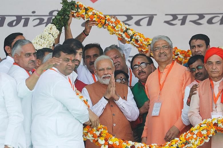 Lots of colour and festivities as Prime Minister Narendra Modi (centre) meets party supporters at a campaign rally in Meerut, in the northern state of Uttar Pradesh.