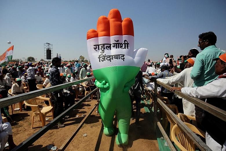 A supporter wearing an inflatable symbol of India's opposition Congress party at a public meeting in Gandhinagar in Gujarat earlier this month. The words read: "Long live Rahul Gandhi".
