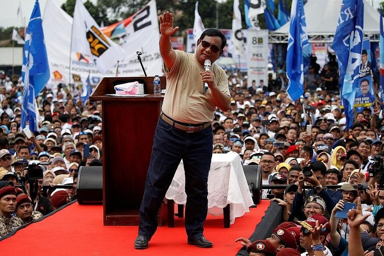 Mr Prabowo Subianto speaking at his rally in Bandung, West Java, yesterday. He called on his "brothers" in the province to hand him and his running mate Sandiaga Uno a resounding victory in the April 17 elections. Indonesia President Joko Widodo at a