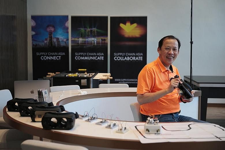 Supply Chain Asia president Paul Lim with some of the gadgets being tested for the industry at the Trade Association Hub in Jurong earlier this week. Start-ups have already come up with ideas that can impact the sector, with innovations like high-tec