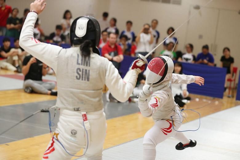 Maxine Wong, 18, on the attack against her national and RI teammate Rachel Lim, 16, in the A Division girls' foil final at the OCBC Arena. She raced to a 10-2 lead after the first round and closed off the bout 15-5.