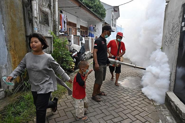 Mosquito fogging being carried out in Banten, Indonesia. The threat of mosquito-carried viruses can be lowered through measures such as using insect spray, but the more effective way to limit expansion of the diseases is to curb climate change and fu
