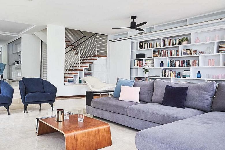 (From far left) Velvet blue chairs add colour to the monochromatic palette; sliding doors and windows let plenty of natural light into the kitchen; and windows above the entrance allow heat to dissipate from the interior of the home. (Above) As the h