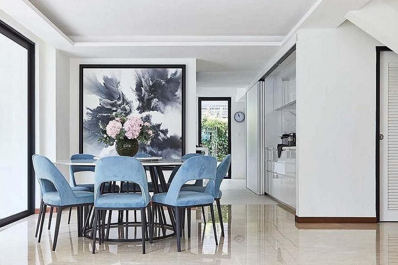 (From far left) Velvet blue chairs add colour to the monochromatic palette; sliding doors and windows let plenty of natural light into the kitchen; and windows above the entrance allow heat to dissipate from the interior of the home. (Above) As the h