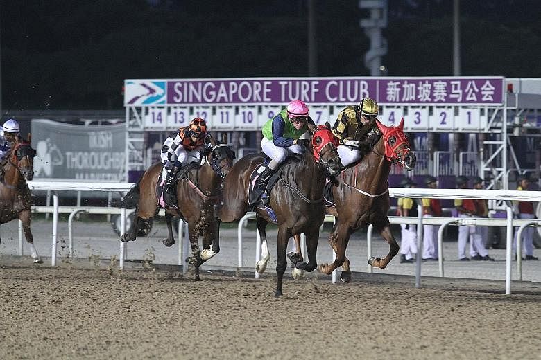 Athletica (pink cap) racing away to beat outsider Storm Ryker (inside) at Kranji last night.