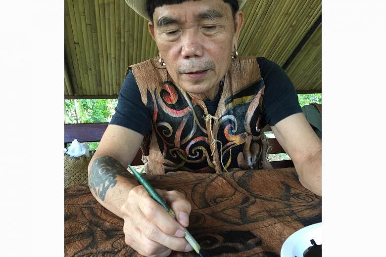Above: The bamboo pavilion with walls that make music at the Rainforest Fringe Festival in Kuching last June. Left: Artist Matthew Ngau Jau painting the Tree Of Life at the Singapore Botanic Gardens last June.