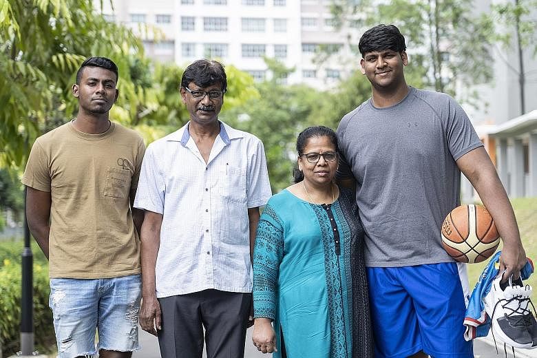 Lavin Raj with (from far left) his older brother V. Hareharan, father Vaithilingam Rajoo, and mother Panimalar A. Thangaveloo. Lavin's father says the family would scour local shops to find size-14 basketball shoes, and XXL jerseys and shorts that fi